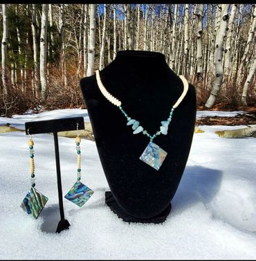 A necklace and earring set with beargrass, abalone, and aquamarine. 