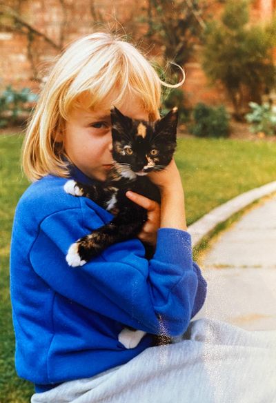 Me as a child with our first cat Poppy