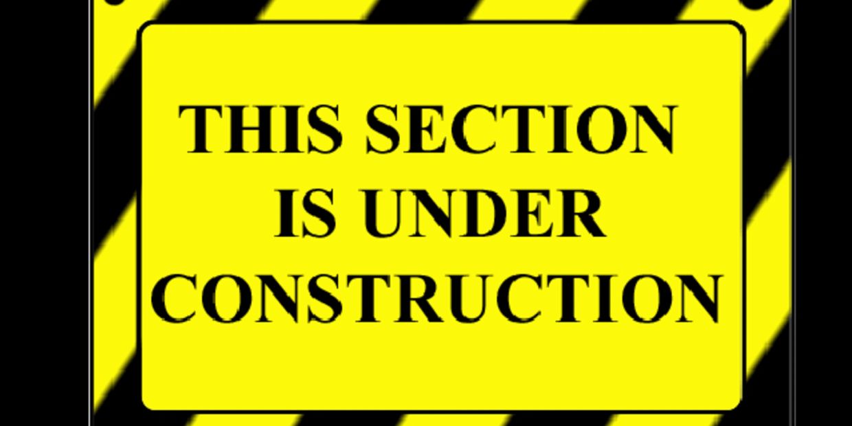 Yellow sign stating this section is under construction with caution stripes.