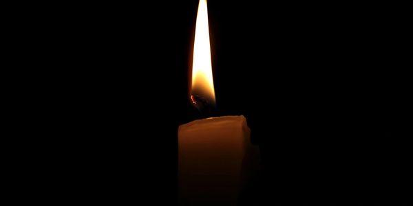 Single Candle flame in black ground