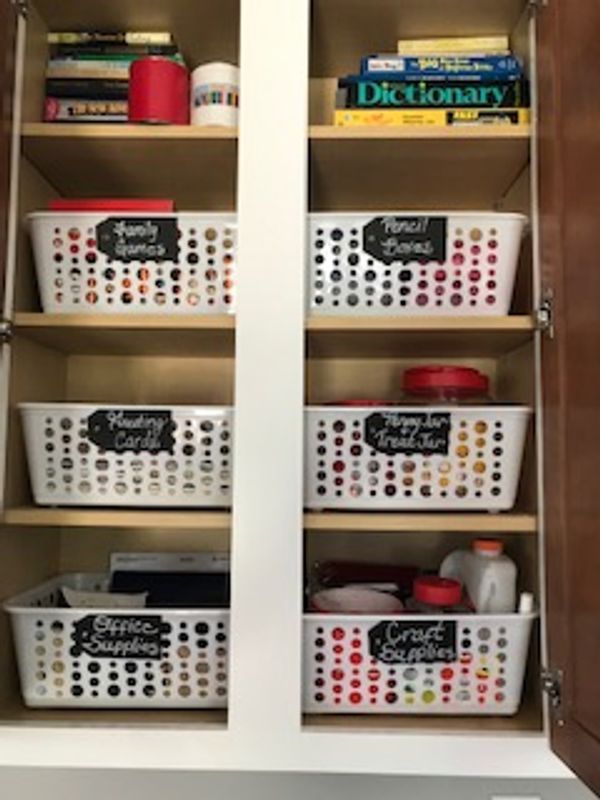 baskets and books in a cabinet