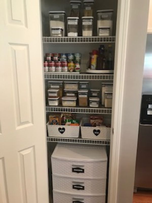 Organized kitchen pantry using OXO containers.
