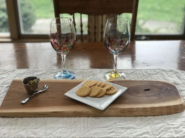 Hickory charcuterie cheese board with prominent knot and contrasting light and dark wood.