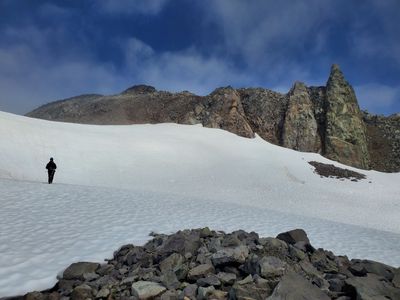 Geologist prospecting, mapping, and sampling in the field  for minerals and commodities