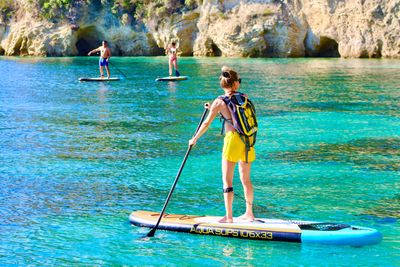 People on SUPs on turquoise water