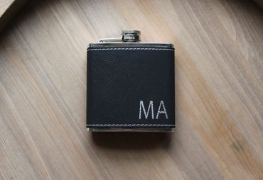 black leather flask with engraving of initials