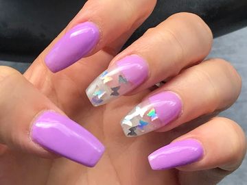 Beautiful long light purple acrylic manicure with embedded multi color butterflies under clear tips