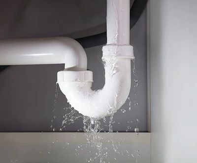 Leaking pipework from a kitchen sink waste pipe