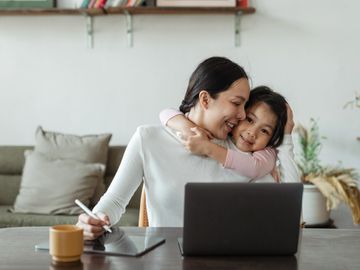 Women working on laptop with her daughter