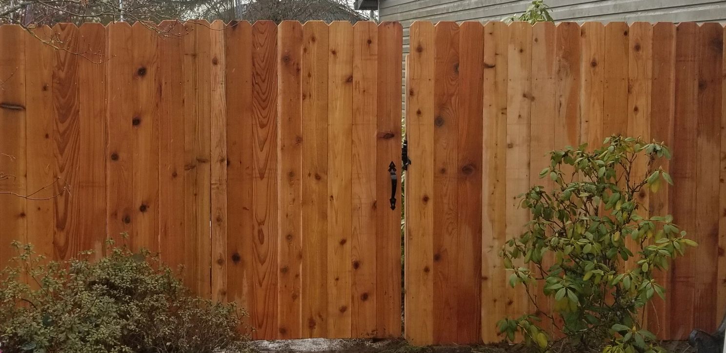 A wooden fence next to a house