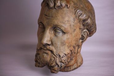 Antique stone head statue of Roman man