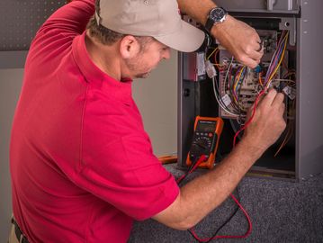 Image of a Technician diagnoses furnace operation