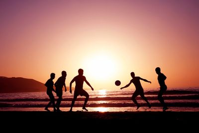 Playing soccer on the beach