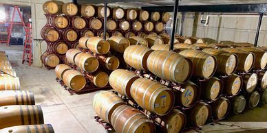 Barrels of wine, stacked in the barrel aging cellar.