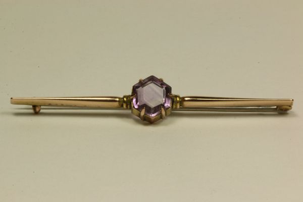 Gold and amethyst stock pin