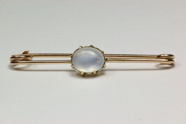 Gold and moonstone stock pin