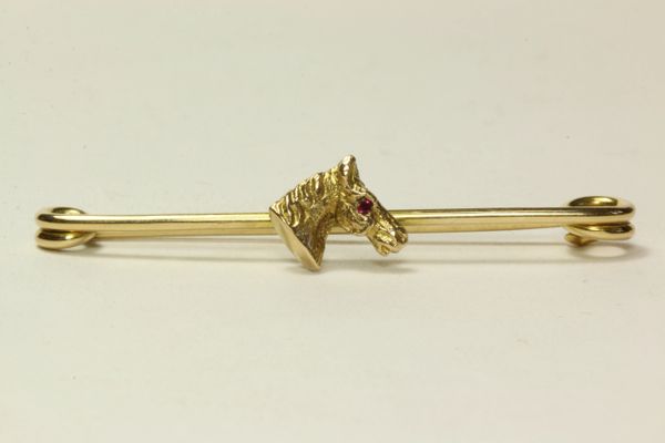 Gold and ruby horsehead stock pin