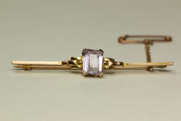 Gold and amethyst stock pin