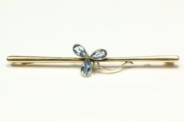 Gold topaz and seed pearl stock pin