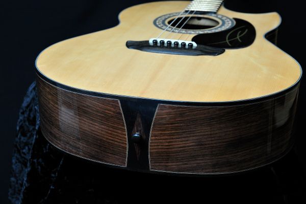 Acoustic Guitar With florentine cutout. Rosewood Back and sides.