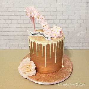Designer cake, birthday cake, drip cake with a shoe and flower. 