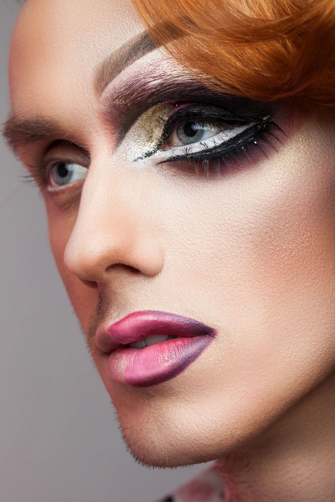 A photo of a man wearing makeup and magnetic lashes.