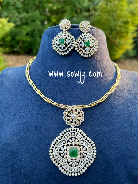 Intricate Designer Work Diamond Look Alike Big Floral Pendant with Big Earrings in A Designer Hasli Dual Tone Twisted Chain - Green Center Stone!!!