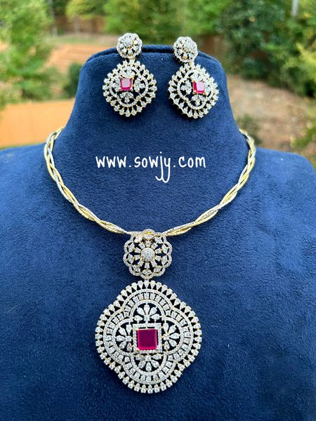 Intricate Designer Work Diamond Look Alike Big Floral Pendant with Big Earrings in A Designer Hasli Dual Tone Twisted Chain - Red Center Stone!!!