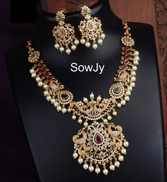 Lovely Kemp Stone Peacock Pendant Short Haaram with Matching Earrings in Gold Finish!