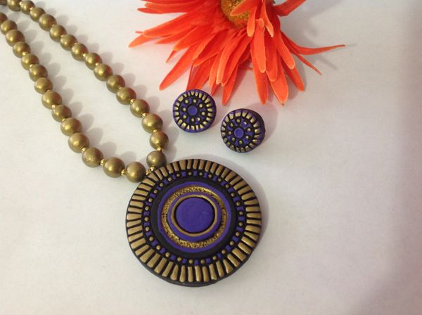 Lovely handmade intricate design carved on Clay in Purple and Antique gold!!!