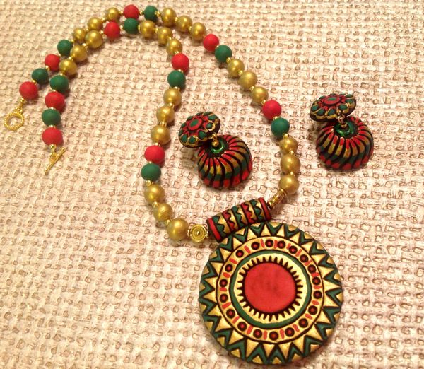 Intricate designs in Red , Green and Gold with Jhumkas!!!!