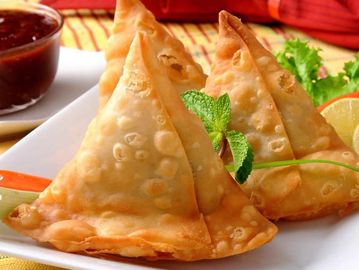 Fried samosas on a plate