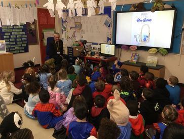 Children in costumes listening to a story.